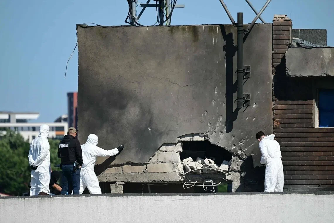 Police and forensic investigators working at the site after a Russian drone struck an apartment building in Galati in eastern Romania, near the border with Ukraine,